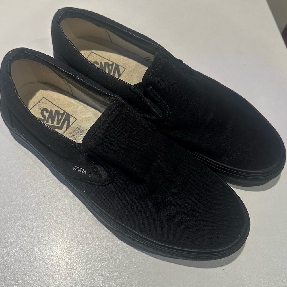 Vans slip-on sneakers, black. Size 11 women, 9.5 men.
